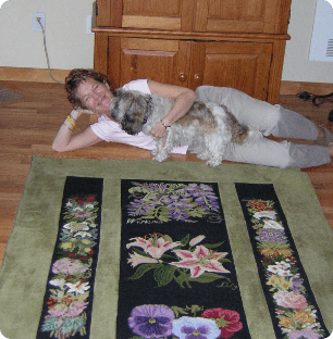 A woman playing with her dog in front of a carpet